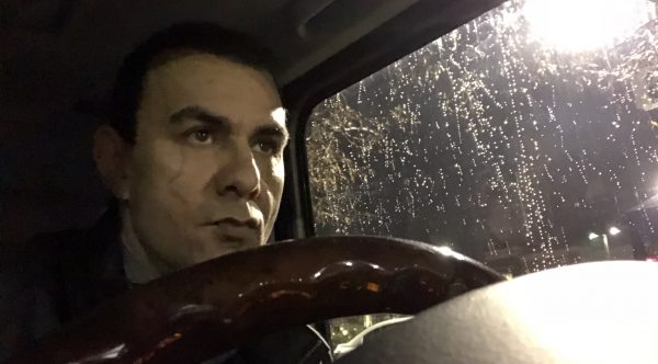 Richar Zaher sitting in a car while it's raining