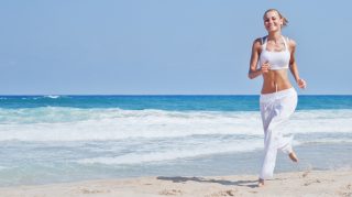 Healthy woman running on the beach